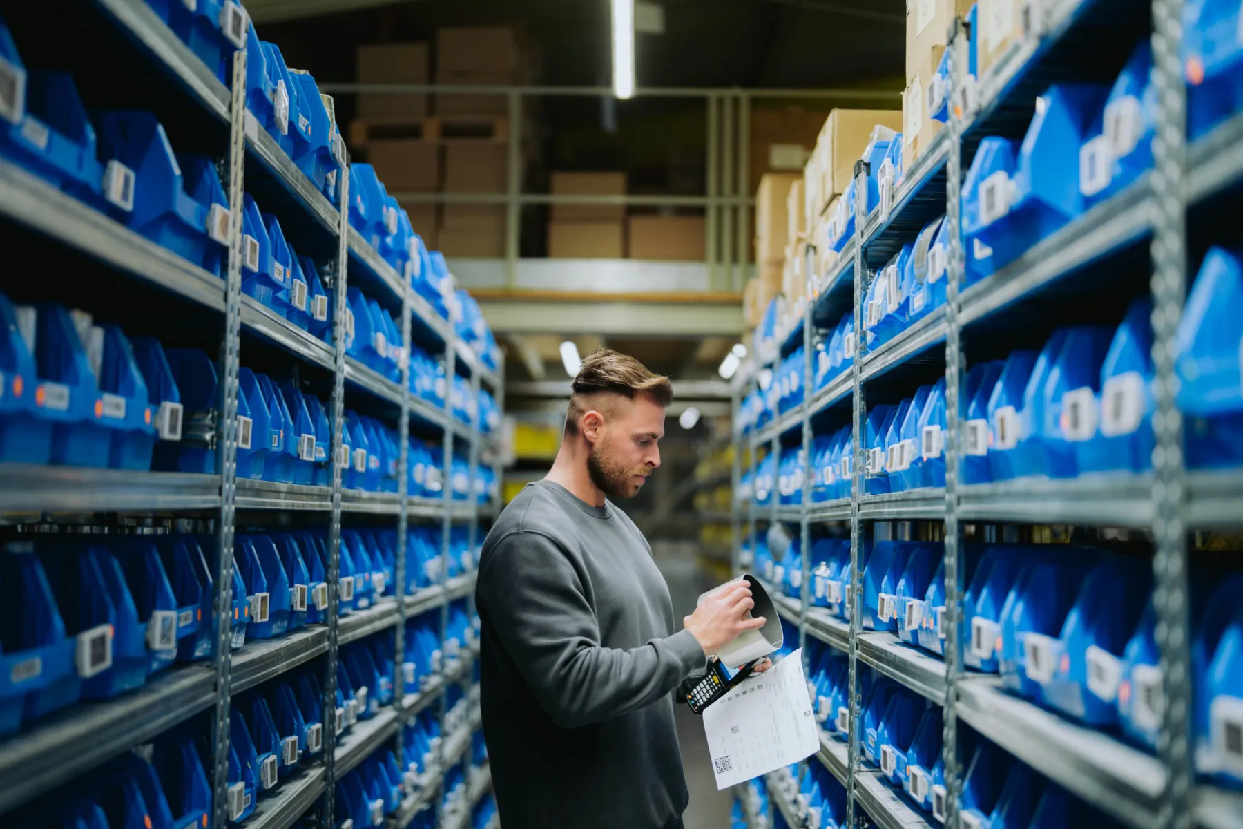 a customer in a high storage warehouse with LED lighting